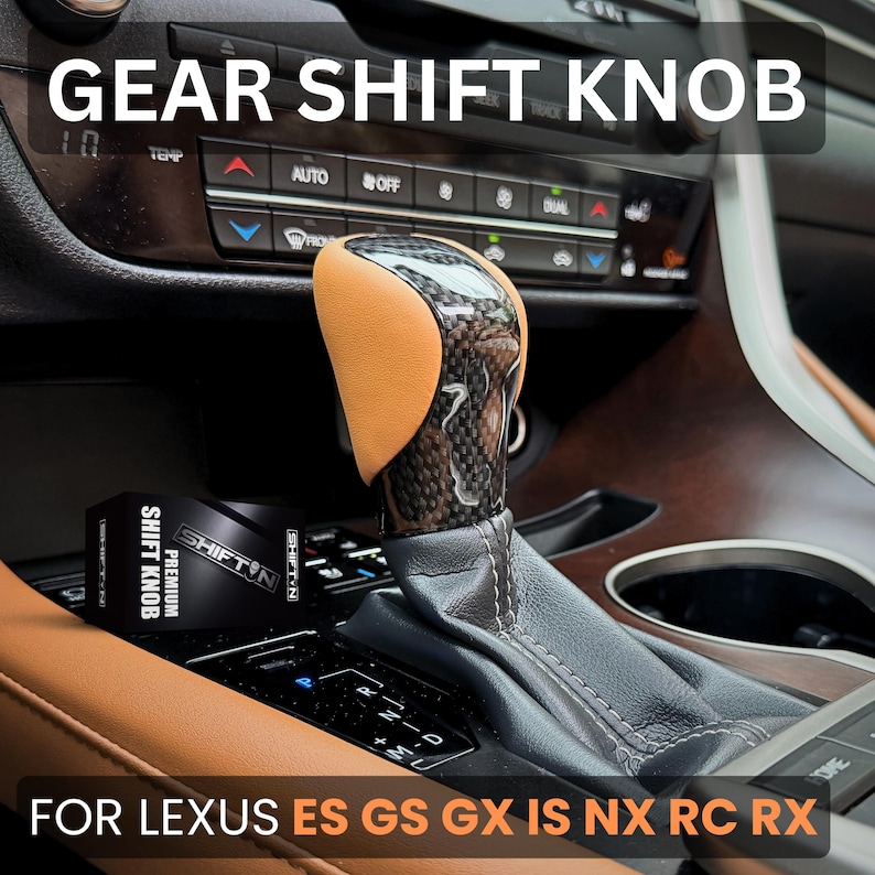 May include: A gear shift knob featuring a tan leather side panel and a glossy carbon fibre finish, installed in a vehicle console. The product is accompanied by a black box labelled SHIFT N PREMIUM SHIFT KNOB. Text on the image reads GEAR SHIFT KNOB FOR LEXUS ES GS GX IS NX RC RX.