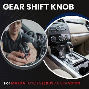 May include: Image features a carbon fiber gear shift knob. The text "GEAR SHIFT KNOB" is at the top. The text "For MAZDA TOYOTA LEXUS ACURA SCION" is at the bottom. The image shows the interior of a car.