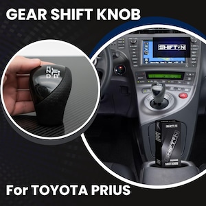 May include: Black gear shift knob for a Toyota Prius. The knob is held in a hand and features the letters "R, N, D, B". The car's interior is visible in the background, along with a box that says "SHIFT-N PREMIUM SHIFT KNOB". The text "GEAR SHIFT KNOB" and "For TOYOTA PRIUS" are also visible.