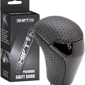 May include: A black premium shift knob with a perforated leather top and a glossy black base. The product is packaged in a black box with the brand name "SHIFTIN" and product details.