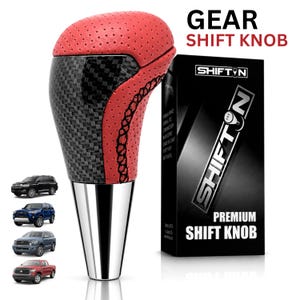 May include: A gear shift knob featuring a red perforated top section, a black carbon fiber pattern body, and a silver metallic base. The product is displayed next to its black packaging box labeled SHIFTN PREMIUM SHIFT KNOB and four small vehicle images.