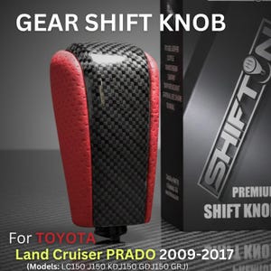 May include: A gear shift knob featuring a black carbon fiber center panel flanked by textured red sides. The product is displayed next to its packaging, which includes the text GEAR SHIFT KNOB, SHIFTON, and information for Toyota Land Cruiser PRADO 2009-2017.