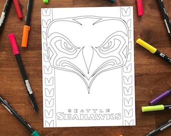 May include: A black and white coloring page featuring a stylized eagle head with the text "SEATTLE SEAHAWKS" below. The eagle head is surrounded by a border of repeating "V" shapes.