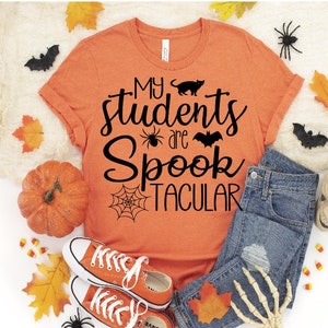 May include: Orange t-shirt with black text that reads "My students are Spooktacular" with a spider, bat, and cat graphic.