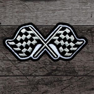 May include: Embroidered patch featuring two crossed checkered racing flags. The flags are black and white, with a black border and white accents. The patch is designed for application on clothing or accessories.