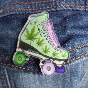 May include: A green and purple roller skate with a marijuana leaf design and the text "High Roller" on the side.