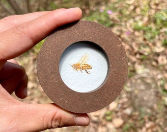 Tiny painting of honeybee in round wooden frame