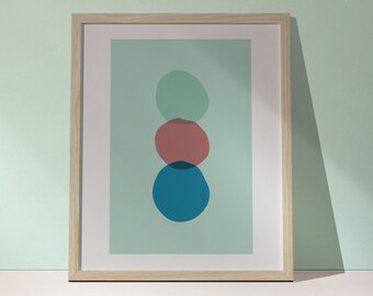 May include: A framed abstract art print with three overlapping circles in shades of teal, blue, and pink on a light green background.