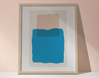 May include: A framed abstract art print with a blue and pink design. The print features two overlapping shapes, one blue and one pink, with a white background.