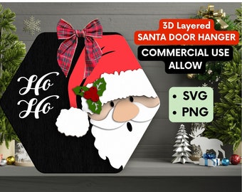 May include: A 3D layered Santa door hanger with the text "Ho Ho" in white on a black background. Santa's face is peeking out from behind a red hat with a plaid bow. The hanger is made for commercial use and comes in SVG and PNG formats.
