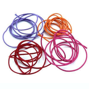 May include: Four spools of cord in different colors: purple, orange, pink, and red. The cords are all the same thickness and are coiled up.