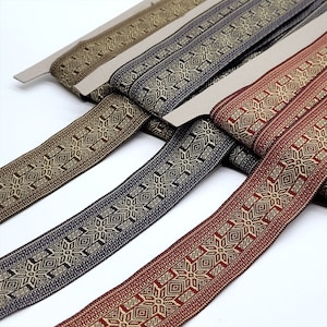 May include: Four different colors of woven trim with a geometric pattern. The trim is gold, brown, navy blue, and burgundy.