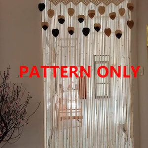 May include: A macrame curtain with a pattern of hearts and beads. The curtain is made of natural fiber rope and is hanging in a doorway. The text "PATTERN ONLY" is visible in the image.