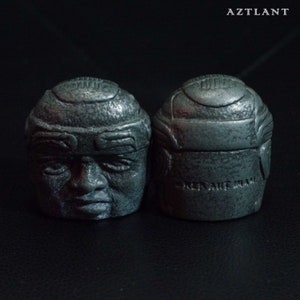 2 sculptures of the Olmec head