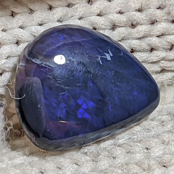 3.7 carat black opal freeform cabochon from Lightning Ridge, Australia