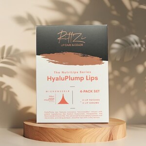May include: A box of Pitt Zi Lip Care & Color HyaluPlump Lips, a 4-pack set. The box features the text "MICRONEEDLE" and "4 LIP PATCHES + 4 LIP SERUMS". The box is on a small, round wooden stand.