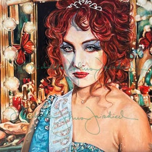 May include: A painting of a woman with red curly hair wearing a tiara and a sash that says "Miss" with rhinestones. She is wearing heavy makeup and a blue sequined dress. The background is a mirror with lights and a red butterfly.