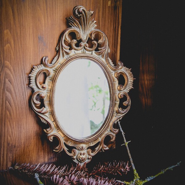 Completely gorgeous antique French gold wall mirror in ornate style; wooden carved and backed oval mirror in beautiful condition.