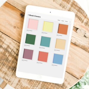 Może przedstawiać: Biały tablet wyświetla ekran zatytułowany "Okładki książek" z dziewięcioma kolorowymi projektami okładek. Okładki są w r&oacute;żnych kolorach, w tym r&oacute;żowym, ż&oacute;łtym, zielonym, turkusowym, fioletowym, czerwonym i niebieskim, każda o wymiarach 30,48 cm x 30,48 cm.