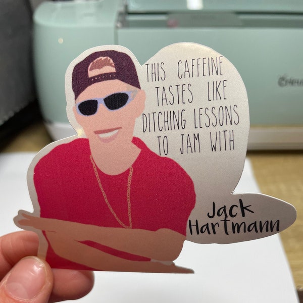 May include: A sticker featuring a cartoon illustration of a person wearing sunglasses and a red shirt with the text "This caffeine tastes like ditching lessons to jam with Jack Hartmann".