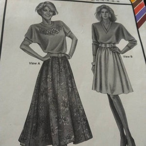 May include: A sewing pattern for a 6-gore skirt. The pattern includes two views, one with a floral print skirt and the other with a solid skirt. The pattern is designed for hip sizes 32-48 inches. The pattern is called "Stretch & Sew" and the number is 481.