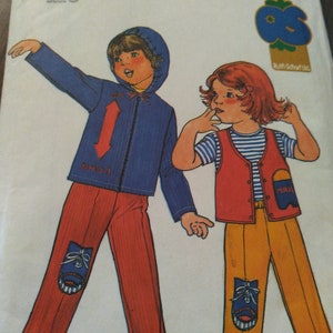 May include: A vintage sewing pattern for children's clothing. The pattern is for a blue jacket with a red arrow and a pair of red pants with a blue shoe design. The second pattern is for a yellow vest with a blue and white striped shirt and a pair of yellow pants with a blue shoe design. The pattern number is 6722 and the price is $1.75.