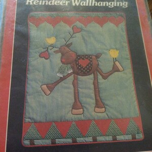 May include: A vintage craft pattern for a reindeer wall hanging. The pattern includes full-size appliqué patterns and instructions. The finished size is approximately 21 inches by 27 1/2 inches.