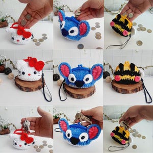 May include: A collection of handmade crochet coin purses in various character designs. The purses include a white cat with a red bow, a blue alien with pink ears, and a yellow and black bee. Each purse has a black wrist strap.