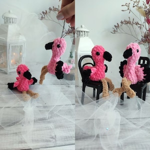 May include: Three pink flamingo plush toys with black accents. One flamingo is sitting on a black chair, another is sitting on a white surface, and the third is hanging from a string.