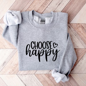 May include: Gray sweatshirt with the text "CHOOSE &hearts; happy" in black lettering.