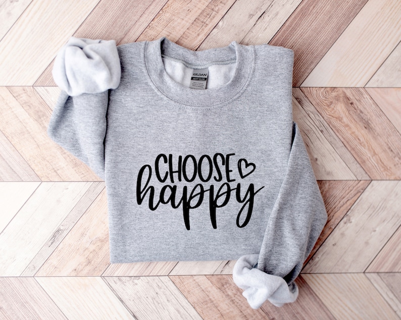 May include: Gray sweatshirt with the text "CHOOSE &hearts; happy" in black lettering.