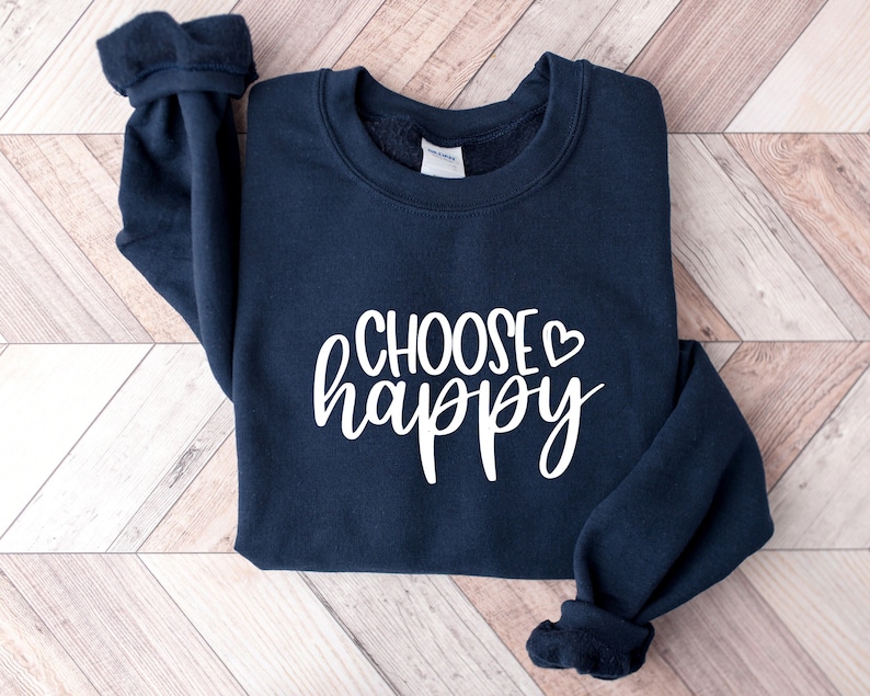 May include: A navy blue sweatshirt with the text "CHOOSE happy" in white lettering with a small white heart.