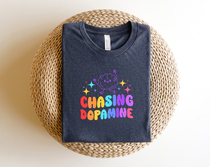 May include: A dark gray t-shirt with a rainbow graphic of a brain with the text "Chasing Dopamine".