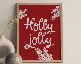 Może przedstawiać: Wydruk w ramie z czerwonym tłem i białym tekstem, który mówi "Holly Jolly" z białymi ilustracjami liści ostrokrzewu i ozdób.