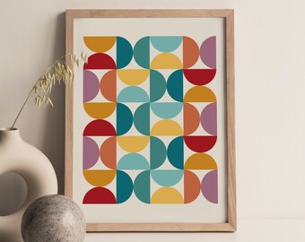 May include: A framed print with a geometric pattern of colorful semi-circles in shades of red, orange, yellow, teal, and purple.
