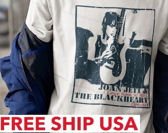 May include: A white t-shirt with a black and white graphic print of Joan Jett and the Blackhearts. The text on the graphic reads "I Love Rock 'n' Roll" and "The Blackheart Concert".