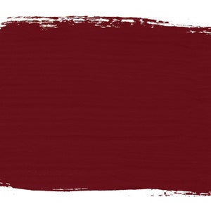 May include: A solid, dark red paint swatch with a rough, textured surface. The paint is applied with a brush stroke, creating a slightly uneven edge.