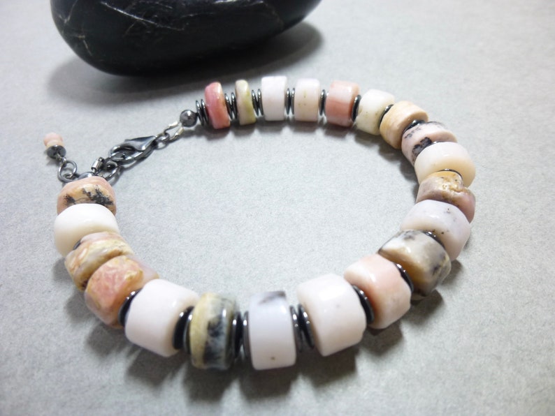This Pale pink Peruvian Opal bracelet features chubby rondelle stones with natural gray Hematite accent stone disks. It closes with an oxidized sterling silver lobster clasp and has a tiny pink Peruvian opal stone dangle that hangs from the clasp.