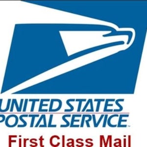 May include: The United States Postal Service logo, a blue and white emblem featuring a stylized eagle. Below the logo, the text reads "UNITED STATES POSTAL SERVICE" and "First Class Mail."