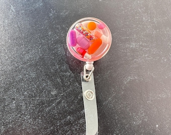 Purpled Orange Chill Pill Badge Reel