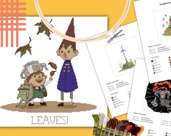 Puede incluir: Un patrón de punto de cruz con dos personajes de dibujos animados, uno con sombrero de tetera y una rana, el otro con abrigo morado, hojas cayendo y el texto LEAVES! debajo, junto con hojas de información del patrón y hilos de bordar.