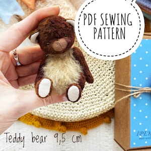 May include: A brown and cream teddy bear sewing pattern. The pattern is for a 9.5 inch teddy bear. The pattern is in a PDF format. The image also shows a small box with the text "IPEK made with love" on it.