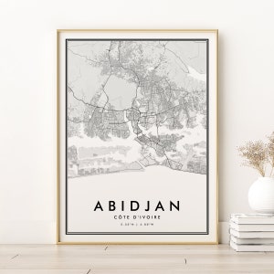 May include: Black and white city map print of Abidjan, Côte d'Ivoire with the city name and coordinates in the bottom right corner.