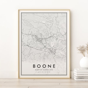 May include: A black and white map print of Boone, North Carolina. The map shows the city's streets and landmarks. The text "BOONE NORTH CAROLINA 36.21°N 81.67°W" is printed below the map.
