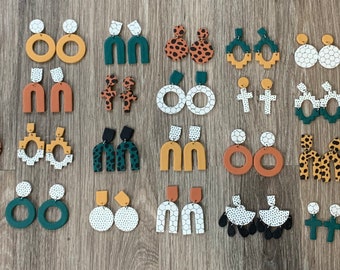May include: A collection of 36 pairs of handmade polymer clay earrings in various shapes, colors, and patterns. The earrings feature geometric shapes, animal prints, and abstract designs. The colors include green, brown, white, black, and gold.