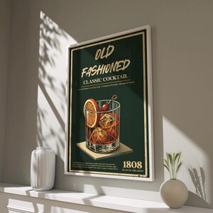 May include: A vintage-style poster with a green background featuring a glass of Old Fashioned cocktail with an orange slice and a cherry. The text reads "Old Fashioned Classic Cocktail" and "1808 Year of Creation".