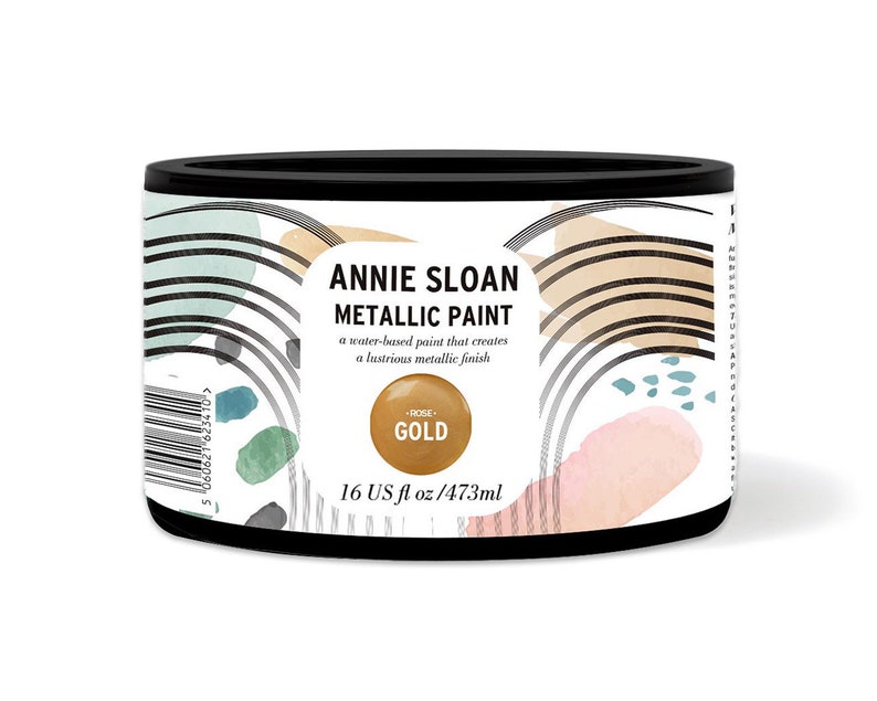May include: A round metal can of Annie Sloan Metallic Paint in Rose Gold. The can is 16 fluid ounces or 473 milliliters. The can has a white label with black text and a gold circle with the words "Rose Gold" in black text.