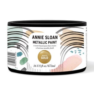 May include: A round metal can of Annie Sloan Metallic Paint in Modern Gold. The can is 16 fluid ounces or 473 milliliters.