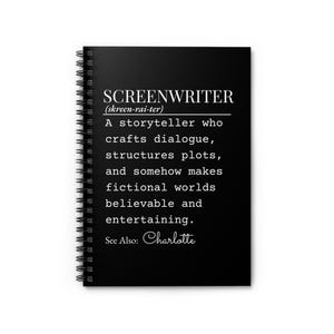 May include: A black spiral-bound notebook featuring white text that defines the word screenwriter as a storyteller who crafts dialogue, structures plots, and makes fictional worlds believable and entertaining, with the additional text See Also: Charlotte.
