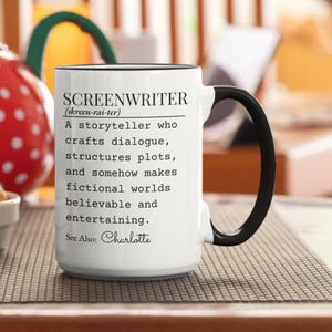 May include: White ceramic mug with a black handle and rim. The mug features the word "SCREENWRITER" and a definition, along with the name "Charlotte". A perfect gift for writers.